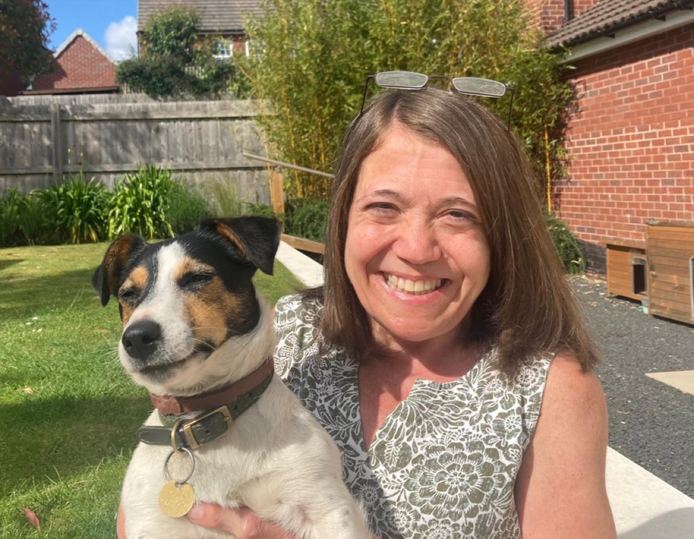 Emma smiling with a dog